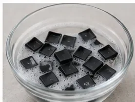 A second bowl view showing removable black keycaps soaking in mild soapy water.